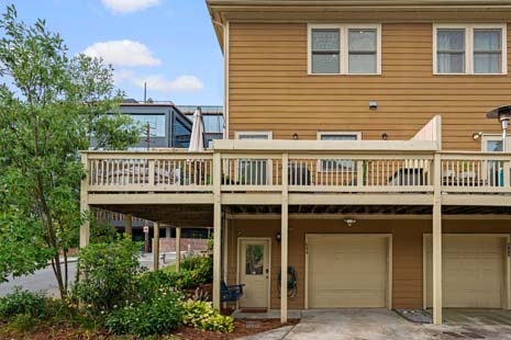 Back view of the house, deck, and garage